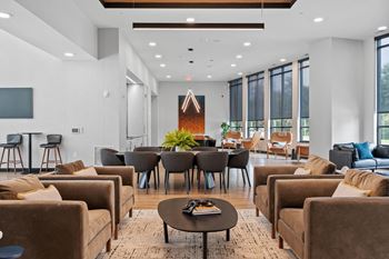 a living room with couches and chairs and a table